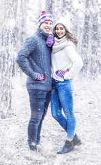 Happy young couple in winter in the snow.