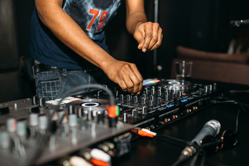 Close up of DJ's hand playing music at turntable on a party festival - Portrait of DJ mixer audio...