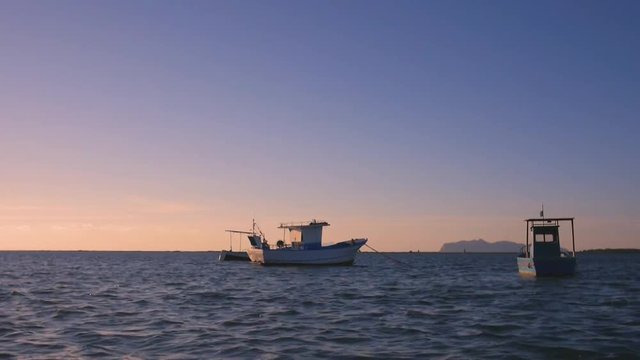 footage at the sunset of the stagnone park near trapani and marsala in sicily in backlight with moored boats
