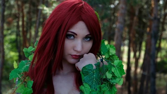 Beautiful girl in a superhero costume posing in the forest. Female Cosplay Character