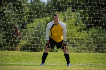 Goalkeeper standing near goal post