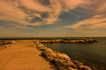 Breakwater. Beautiful sunset view. Mediterranean sea. Puerto Banus, Marbella city, Costa del Sol, Andalusia, Spain.