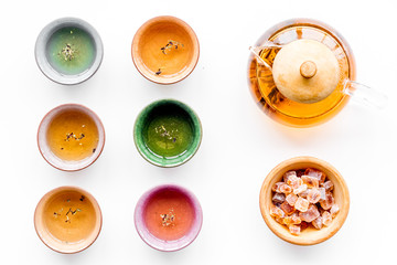 Tea ceremony concept. Tea pot, cups or bowls on white background top view