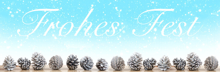Fototapeta na wymiar german words for Merry Christmas with white pinecones on snowy background