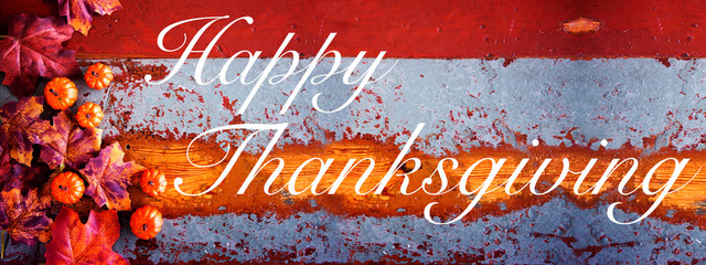 Happy Thanksgiving on vintage wood with pumpkins and leaves