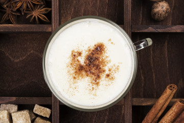 Christmas drink eggnog and ingredients on a green background. Top view
