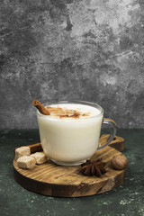 Christmas drink eggnog and ingredients on a green background