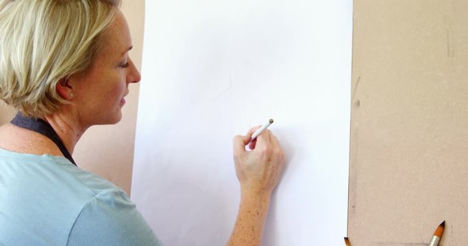 Woman drawing sketch on canvas 