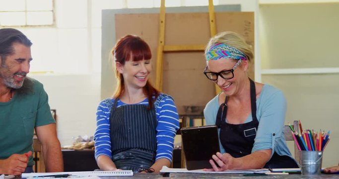 Group of artist using digital tablet at table 