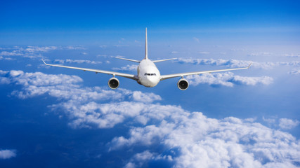 Naklejka na ściany i meble aeroplane flying above clouds. Passenger Airliner flying