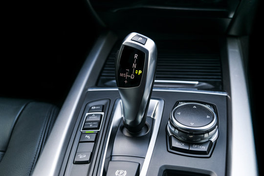 Automatic gear stick (transmission) of a modern car, multimedia and navigation control buttons. Car interior details. Transmission shift.
