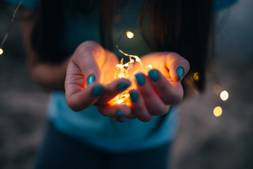 girl with lights in hands