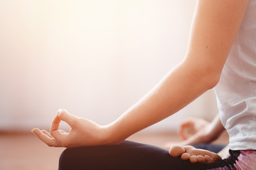 Close up woman meditates while practicing yoga in training hall or home. Concept freedom, calmness and relax, female health happiness.