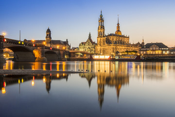 Fototapeta na wymiar The famous church called Hofkirche and a bridge over the river Elbe in Dresden, Germany