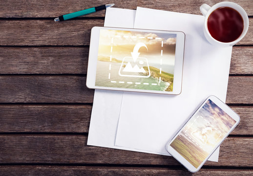 Tablet and Smartphone on Wooden Table with Coffee and Stationery Mockup