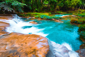 Than sawan Waterfall, Payao, Thailand, Long explosure shot, Beautiful green waterfall in the nature at sunset.