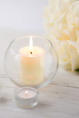 Big palm candle in glass ball with white roses