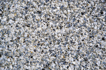 The wall is made of many small stones and concrete