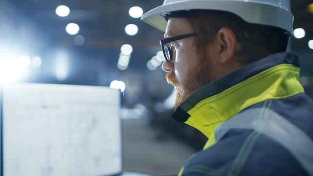 Inside the Heavy Industry Factory Close-up Footage of  Industrial Engineer's Face While He's Working on the Personal Computer Designing Turbine/ Engine in 3D, Using CAD Program.