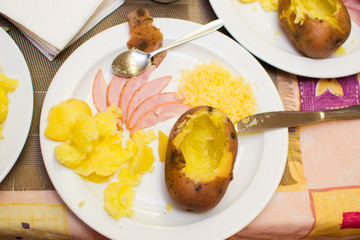children learn how to cook stuffed potatoes in class