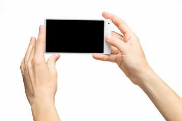 Mockup of female hands holding white frameless cellphone with black screen and making selfie at isolated background.