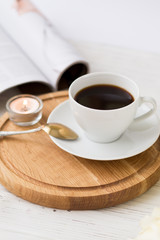 Coffee for breakfast or lunch with decorations, candles and flowers. white roses on the table and cup of coffee