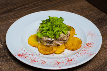 fried potatoes with salad on a plate