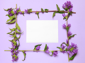 Flower frame made of bells on a lilac background.