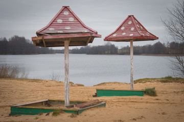 Beach wooden umbrellas on the beach with a red roof.