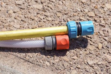 hose pipe and coupling on ground - selective focus on the front