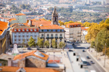 Fototapeta na wymiar Aerial cityscape view on the old town of Porto city during the sunny day in Portugal. Tilt-shift image technic