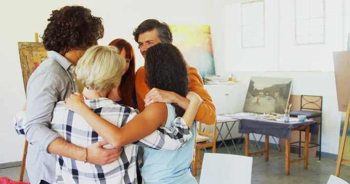 Artists forming huddle in drawing class 
