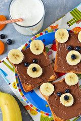 Breakfast for children - toast with chocolate paste, banana and berries. Good morning!