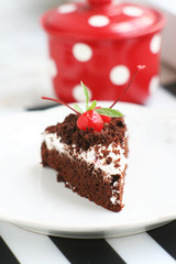 Chocolate cake with cream and cherry