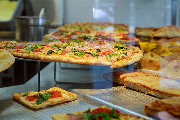 Slice of hot pizza cheese lunch or dinner crust seafood meat topping sauce.