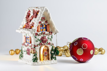 Christmas house and Christmas toy on a background garlands