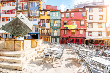 Street view on the beautiful old buildings with portuguese tiles on the Ribeira square in Porto...