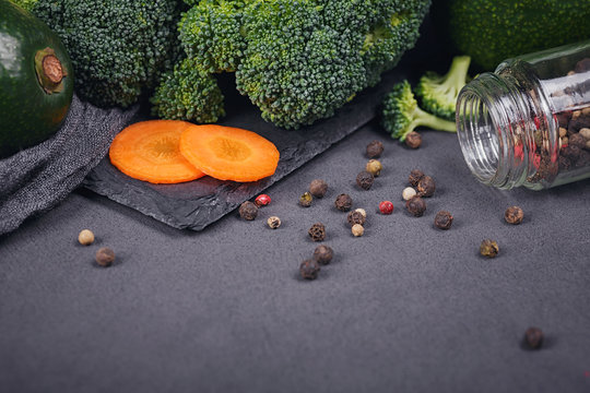 Fresh organic vegetables on dark background. Vegetarian food table ingredients.