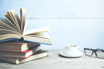 books and cup of coffee on wooden table