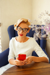 Sexy blonde girl with glasses in retro look