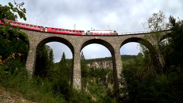 The train passes through the famous Landwasser viaduct in Switzerland. Bottom view.