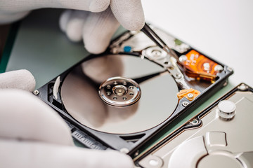 man repairing hard drive in service center. Repairing and fixing service in lab. Electronics repair service concept.