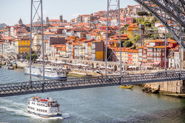 Landscpe view on the Douro river with cruis ship and beautiful iron bridge in Porto city, Portugal
