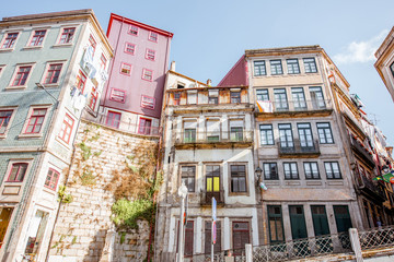 Street view on the beautiful old buildings with portuguese tiles on the facades in Porto city, Portugal