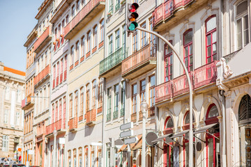 Obraz premium Street view on the beautiful old buildings with portuguese tiles on the facades in Porto city, Portugal