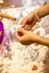 Preparation of dumplings at home in the kitchen for a family dinner in Russia Preparing, cooking, making homemade ravioli, pelmeni or dumplings with meat