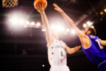 Naklejka premium scoring during a basketball game - ball in hoop - blurred image