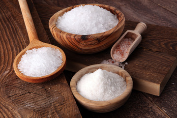 Fototapeta na wymiar differnt kind of salt in wooden bowl and spoon.