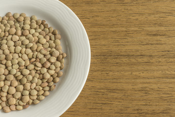 White dish with raw lentil