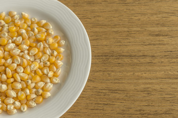 White dish with raw corn